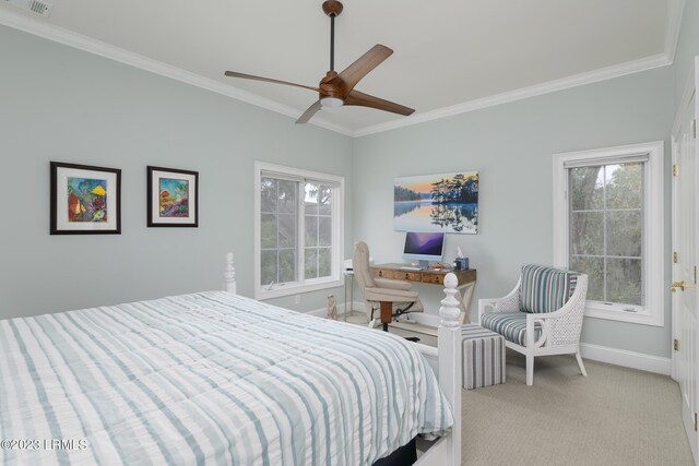 carpeted bedroom featuring ceiling fan and ornamental molding