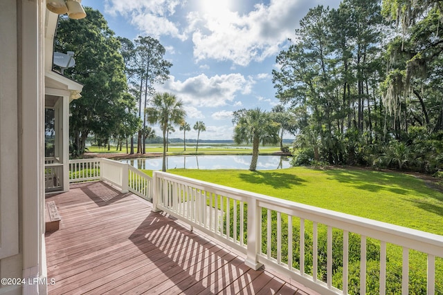 wooden terrace featuring a lawn and a water view