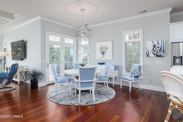 dining area featuring crown molding, a wealth of natural light, and dark hardwood / wood-style flooring