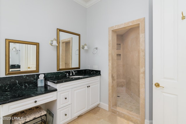 bathroom featuring crown molding, vanity, tile patterned flooring, and a tile shower