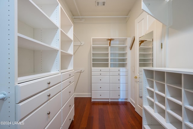 spacious closet with dark hardwood / wood-style floors