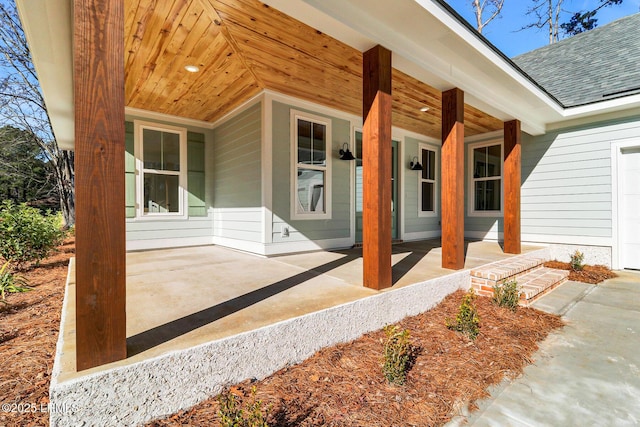 view of exterior entry featuring covered porch