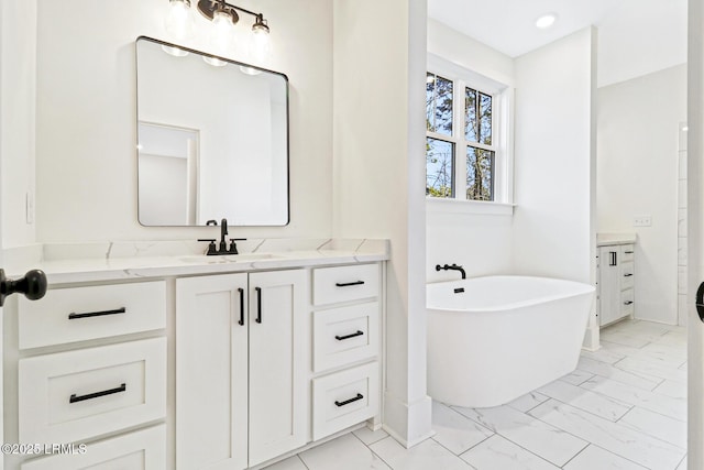 bathroom with vanity and a tub to relax in