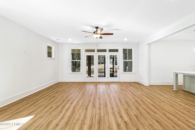 unfurnished living room with light hardwood / wood-style flooring and ceiling fan