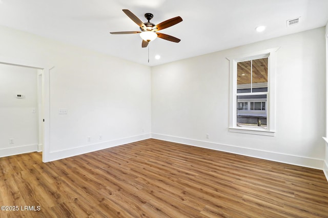 spare room featuring hardwood / wood-style flooring and ceiling fan