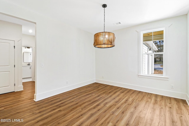 spare room featuring light wood-type flooring