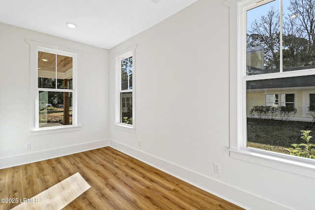 spare room with hardwood / wood-style floors