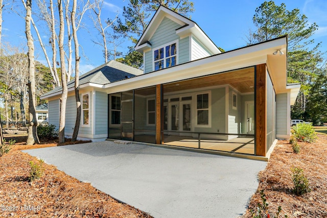 back of property featuring a sunroom and a patio area