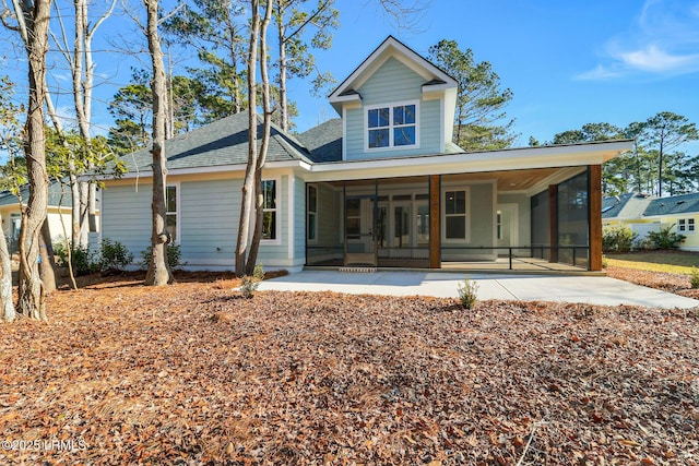 rear view of house featuring a patio and a sunroom