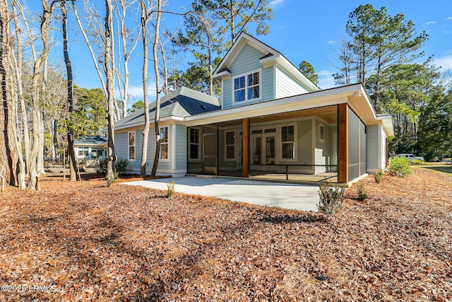 back of house with a patio area and a sunroom