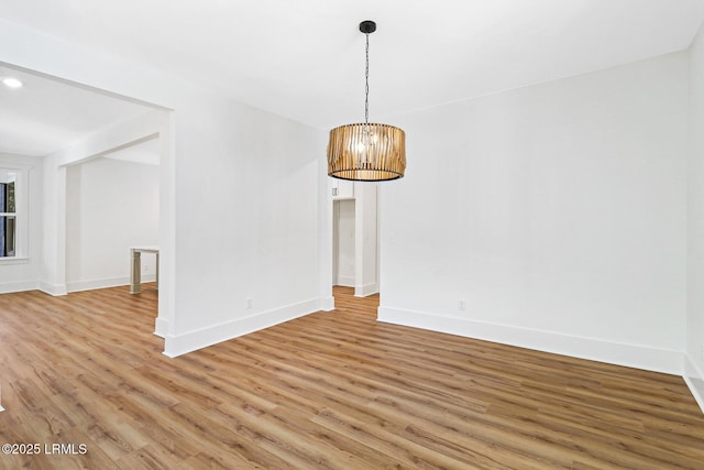 interior space featuring an inviting chandelier and hardwood / wood-style flooring