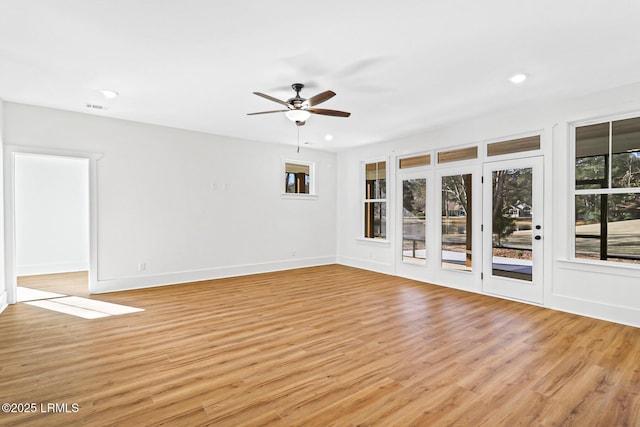 empty room featuring ceiling fan and light hardwood / wood-style floors