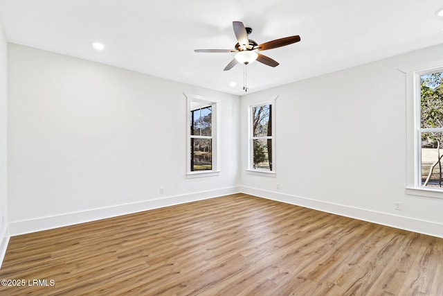 spare room featuring light hardwood / wood-style flooring and ceiling fan