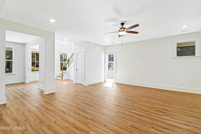 unfurnished living room with ceiling fan and light hardwood / wood-style flooring