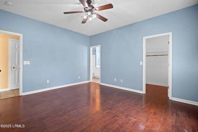 6 Broadland Cir, Bluffton, SC 29910 - unfurnished bedroom with wood finished floors, a spacious closet, baseboards, ensuite bath, and a closet