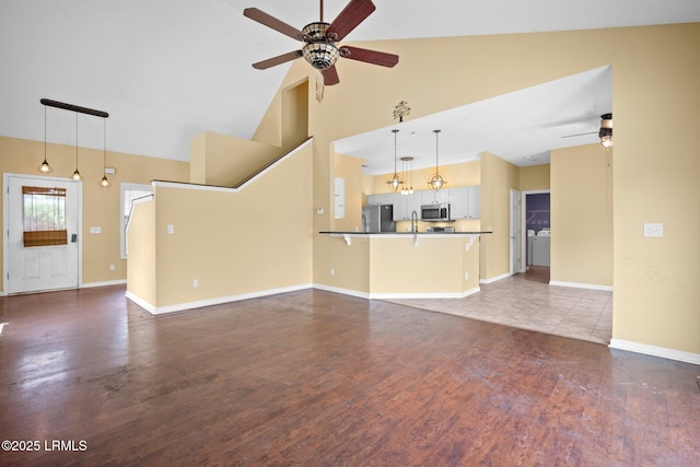6 Broadland Cir, Bluffton, SC 29910 - unfurnished living room featuring a ceiling fan, high vaulted ceiling, baseboards, and wood finished floors