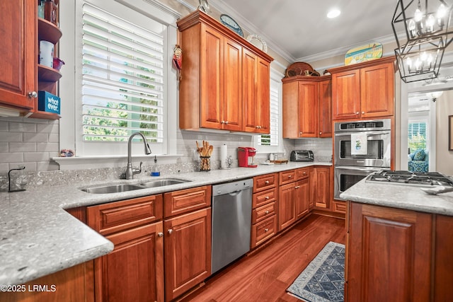 120 Coosaw Club Dr, Beaufort, SC 29907 - kitchen featuring appliances with stainless steel finishes, a sink, plenty of natural light, decorative backsplash, and ornamental molding