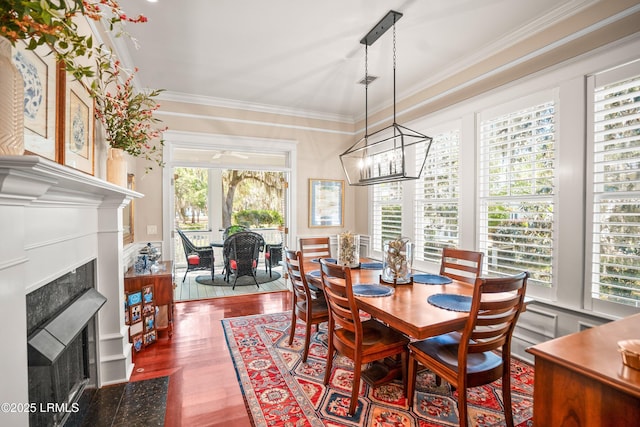 120 Coosaw Club Dr, Beaufort, SC 29907 - dining space featuring a fireplace with flush hearth, healthy amount of natural light, wood finished floors, ornamental molding, and a chandelier
