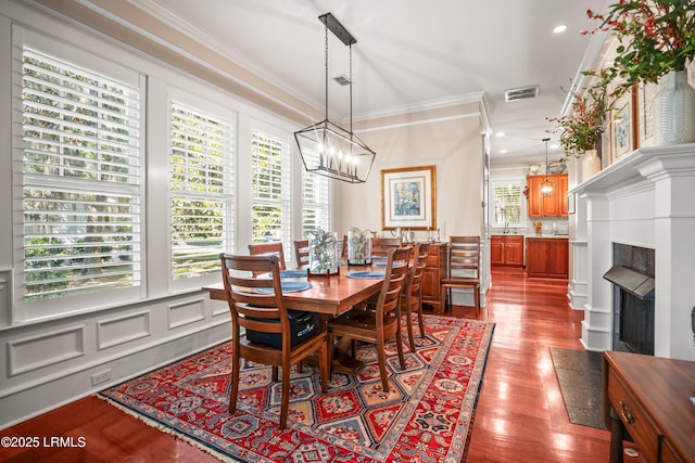 120 Coosaw Club Dr, Beaufort, SC 29907 - dining area with ornamental molding, a chandelier, dark wood-style floors, and recessed lighting