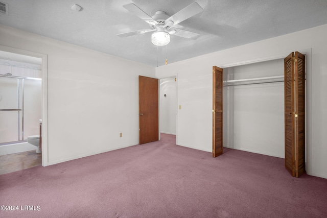 unfurnished bedroom featuring connected bathroom, light carpet, a textured ceiling, a closet, and ceiling fan