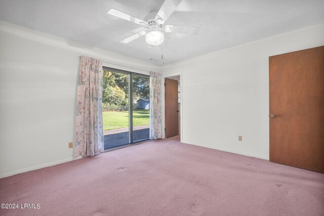 carpeted empty room featuring a textured ceiling and ceiling fan