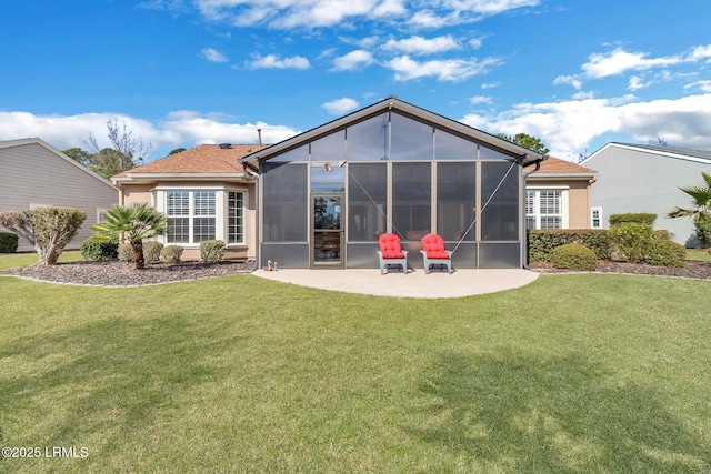 rear view of property with a sunroom, a yard, and a patio