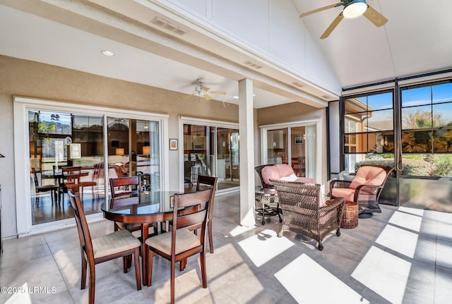 sunroom with vaulted ceiling, ceiling fan, and visible vents