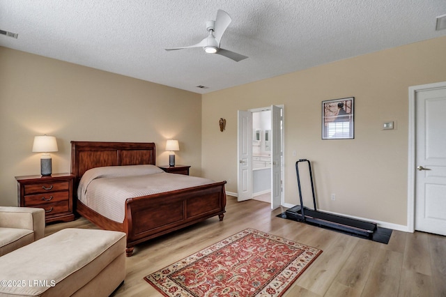 bedroom featuring baseboards, visible vents, and wood finished floors