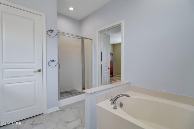 bathroom with recessed lighting, marble finish floor, a garden tub, and a shower stall