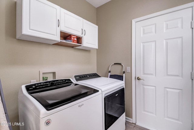 laundry area featuring cabinet space, washing machine and clothes dryer, and light tile patterned flooring