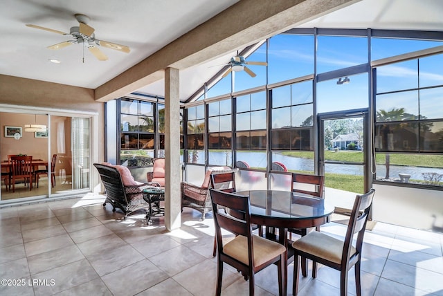 sunroom with a water view, vaulted ceiling with beams, and a ceiling fan