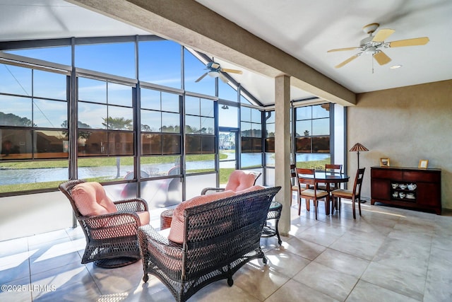 sunroom / solarium featuring vaulted ceiling with beams, a water view, and a ceiling fan