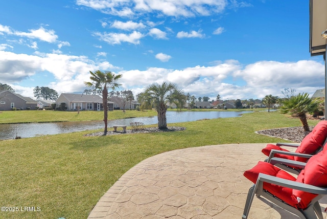 view of patio / terrace featuring a residential view and a water view