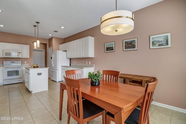 dining area with recessed lighting, visible vents, a textured ceiling, and light tile patterned flooring