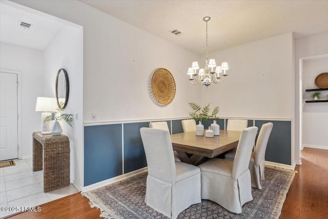 6 Pinyon Dr, Bluffton, SC 29909 - dining space with a chandelier, a textured ceiling, light wood-type flooring, and baseboards