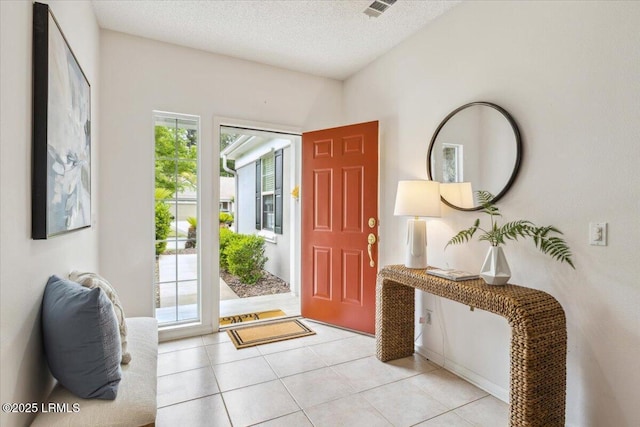 6 Pinyon Dr, Bluffton, SC 29909 - entryway with light tile patterned flooring and a textured ceiling