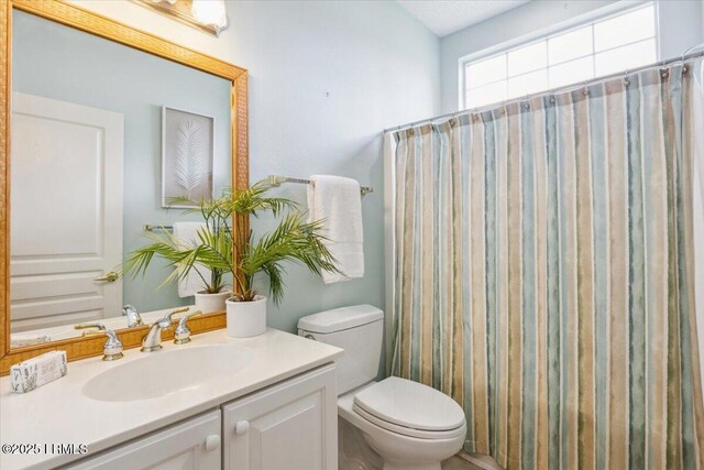 6 Pinyon Dr, Bluffton, SC 29909 - bathroom featuring toilet, vanity, and curtained shower