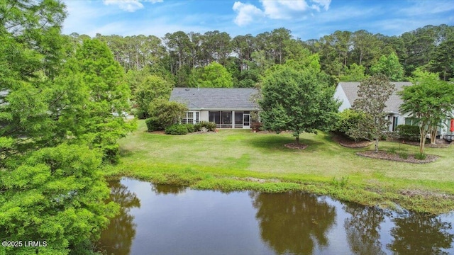 6 Pinyon Dr, Bluffton, SC 29909 - rear view of house featuring a water view, a lawn, and a sunroom