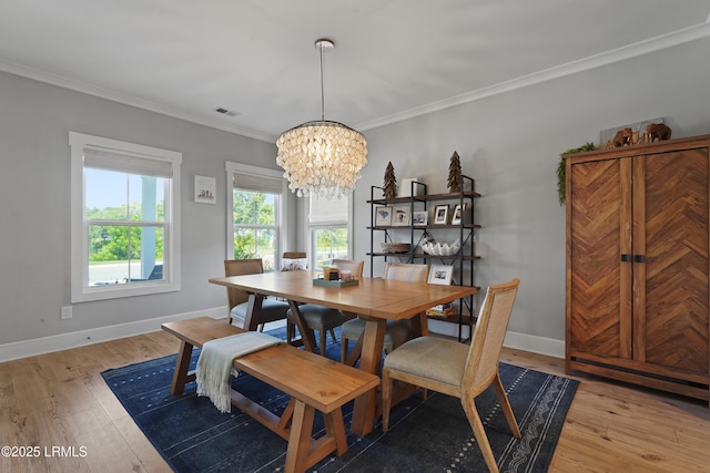 11 Basin Trail St, Beaufort, SC 29902 - dining room featuring a chandelier, light wood-type flooring, baseboards, and crown molding