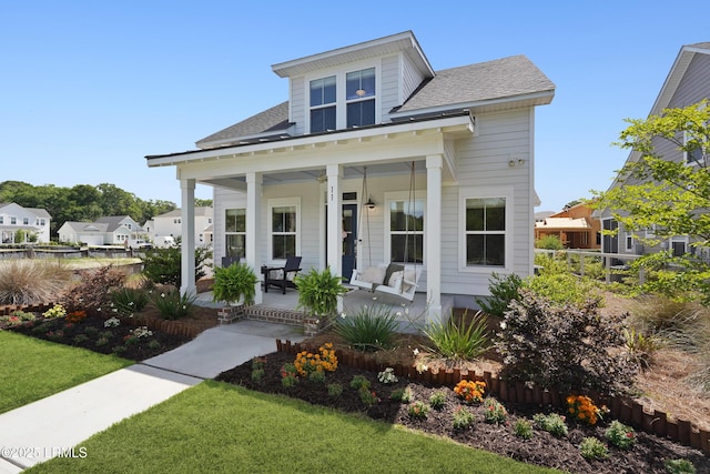 11 Basin Trail St, Beaufort, SC 29902 - view of front of home featuring covered porch, a front lawn, a shingled roof, and a residential view