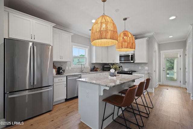 11 Basin Trail St, Beaufort, SC 29902 - kitchen featuring stainless steel appliances, ornamental molding, a sink, white cabinets, and backsplash