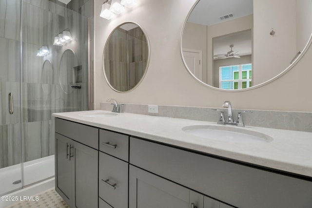 bathroom with ceiling fan, tile patterned floors, vanity, and a shower with door