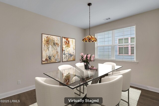 kitchen featuring a center island with sink, light hardwood / wood-style flooring, hanging light fixtures, and white cabinets