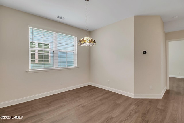 spare room with wood-type flooring