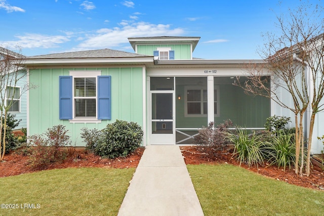 view of front of property with a yard and board and batten siding