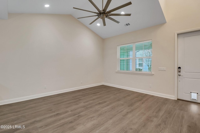 interior space featuring ceiling fan, lofted ceiling, and dark hardwood / wood-style flooring