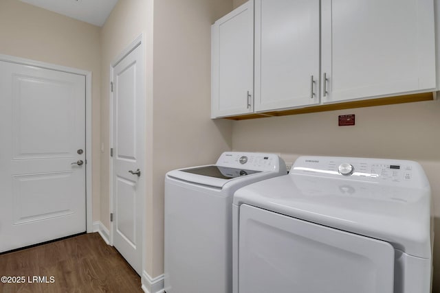 laundry area with cabinets, independent washer and dryer, and dark wood-type flooring