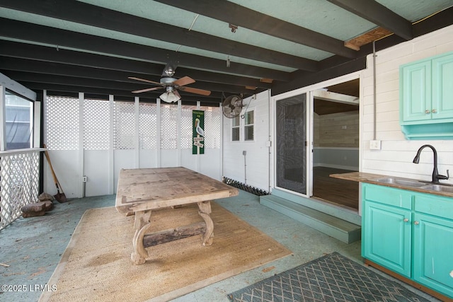 view of patio / terrace with ceiling fan and sink