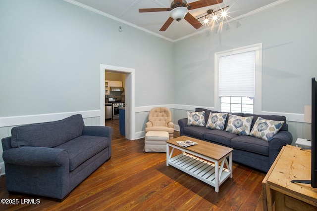 living room with dark hardwood / wood-style flooring, crown molding, and ceiling fan