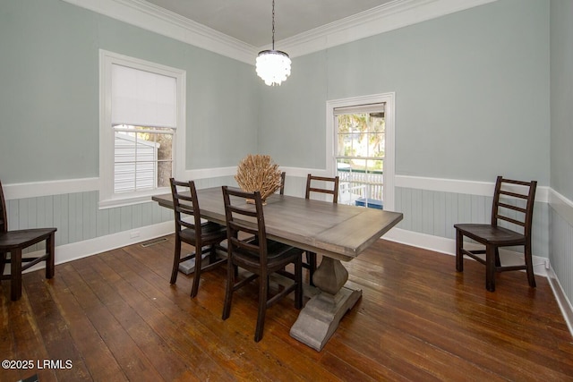 dining space featuring ornamental molding, a chandelier, and dark hardwood / wood-style flooring